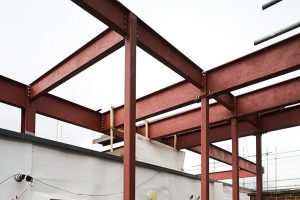 Photo of red steel beams forming a floor structure
