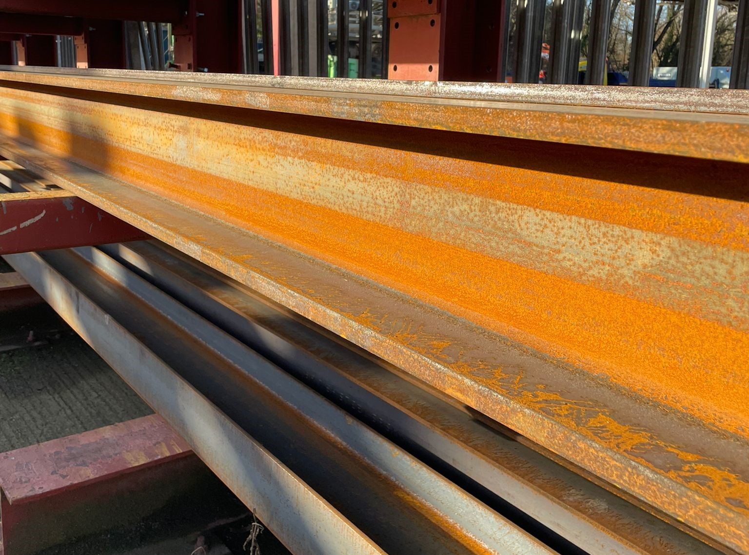 A rusting steel beam with visible corrosion, highlighting the effects of weathering and the importance of rust removal and prevention techniques.